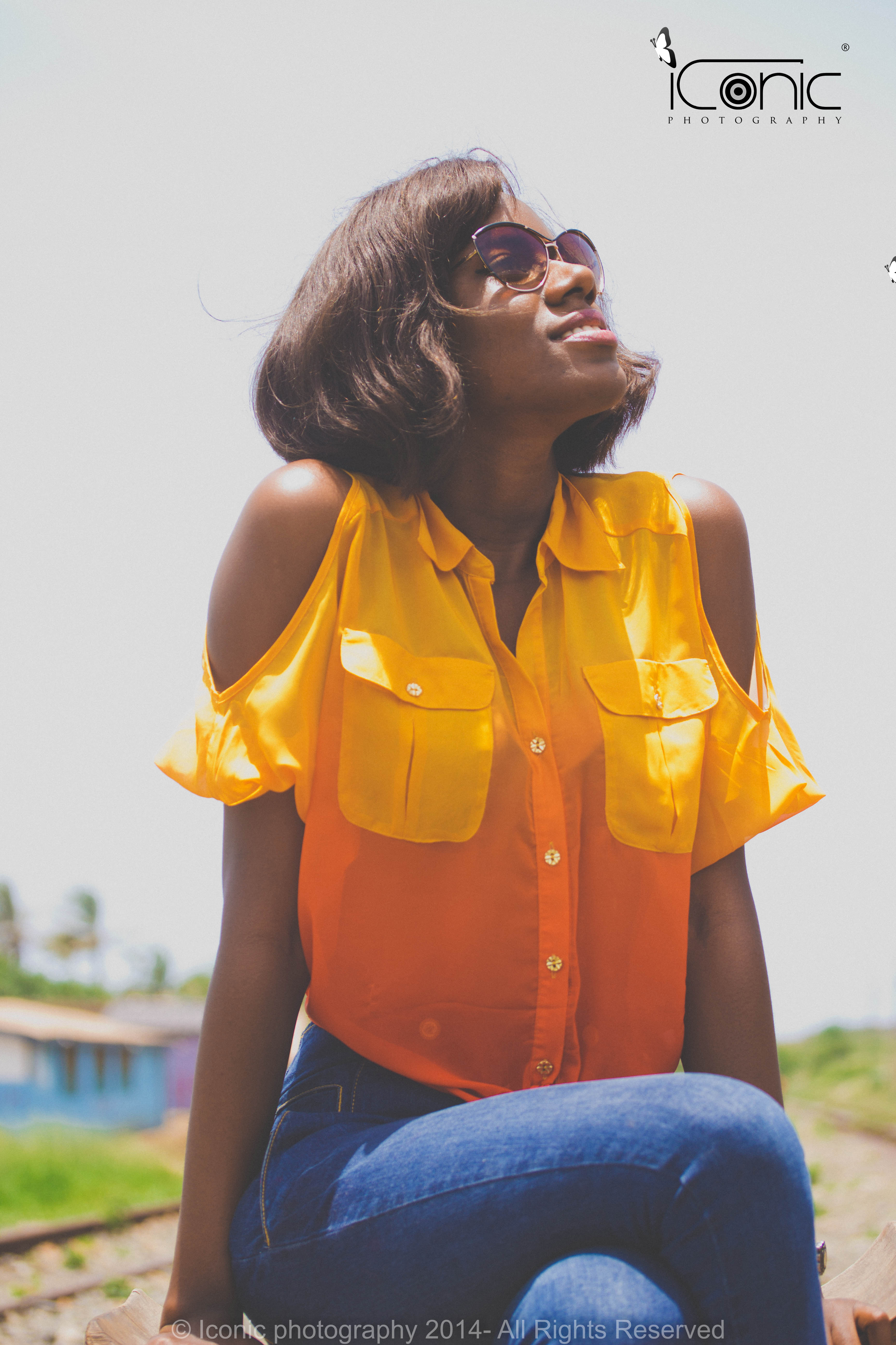 A stack of four white plates sits towards the rear of the image. There is a pile of purple figs, some whole and others cut...